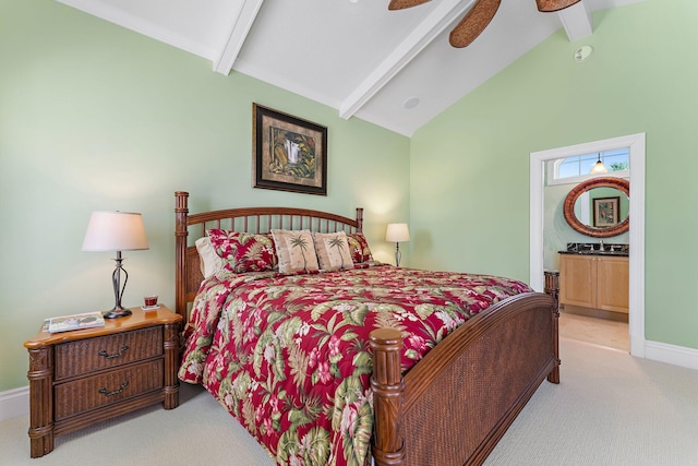 carpeted bedroom featuring lofted ceiling with beams, ceiling fan, and ensuite bathroom