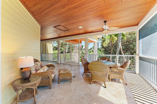 sunroom with ceiling fan, a healthy amount of sunlight, and wooden ceiling