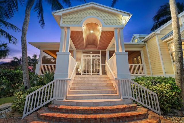 view of exterior entry at dusk