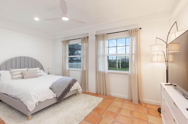 tiled bedroom featuring ceiling fan and crown molding