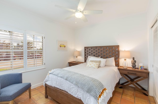 bedroom with light tile patterned floors, ceiling fan, and a closet