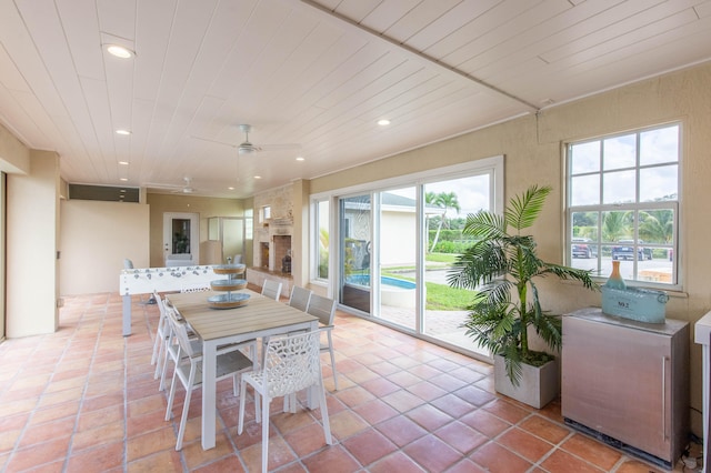 tiled dining area with ceiling fan