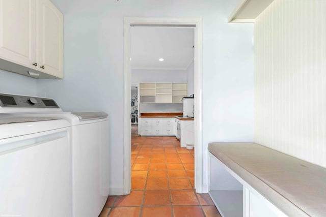 laundry area featuring cabinets, light tile patterned flooring, and washing machine and clothes dryer