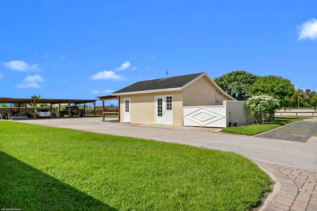 exterior space featuring a yard and a carport