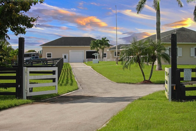 view of front facade featuring a garage and a yard