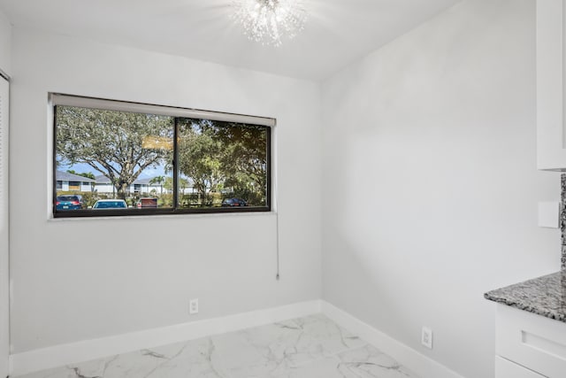 empty room with a notable chandelier