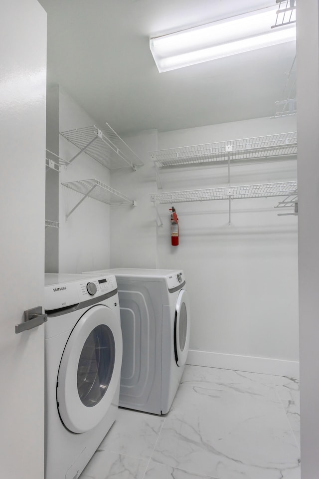 clothes washing area featuring separate washer and dryer