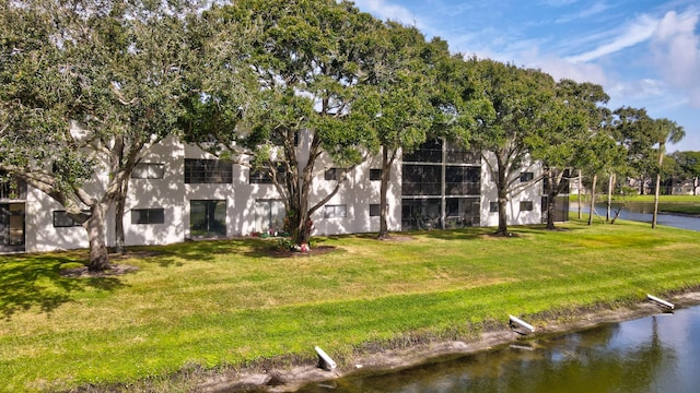 view of community featuring a yard and a water view