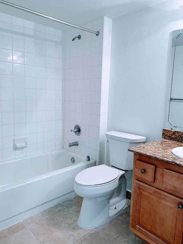 full bathroom featuring toilet, vanity, and tiled shower / bath