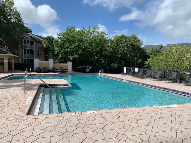 view of swimming pool with a patio area