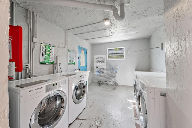 clothes washing area featuring independent washer and dryer