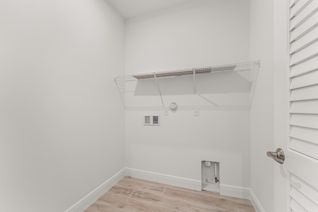 950 SW Prairie Ave, Palm City, FL 34990 - laundry room featuring gas dryer hookup, electric dryer hookup, light wood-style floors, and baseboards