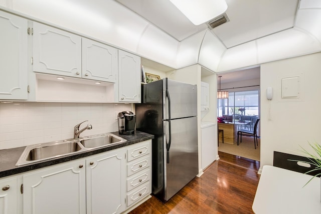 kitchen with white cabinetry, dark hardwood / wood-style flooring, sink, and stainless steel refrigerator