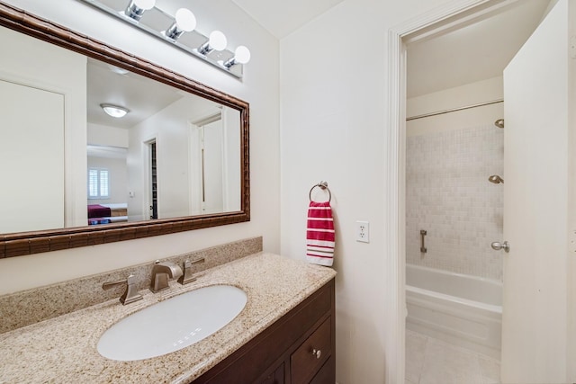 bathroom with vanity, tiled shower / bath combo, and tile patterned floors