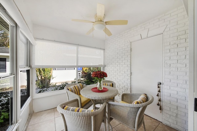 sunroom / solarium featuring ceiling fan