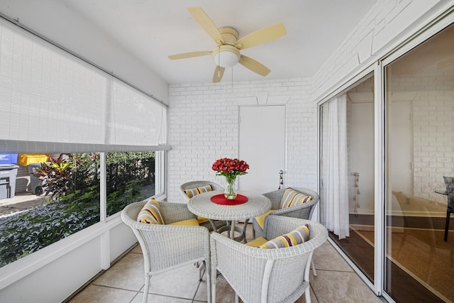 sunroom featuring ceiling fan