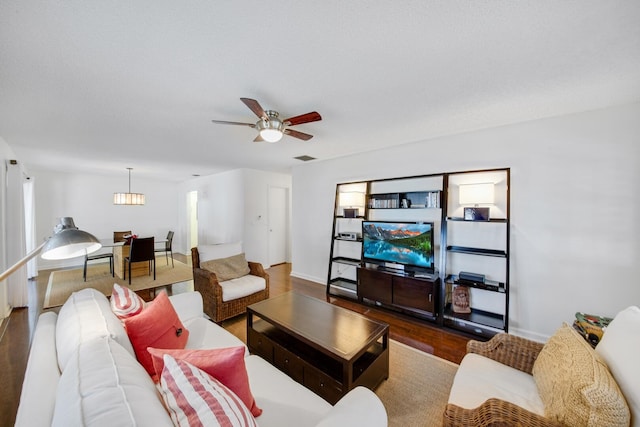 living room featuring hardwood / wood-style flooring and ceiling fan