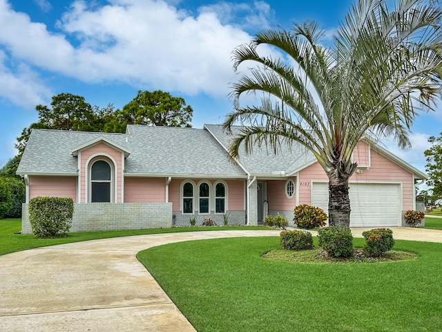 ranch-style home featuring a garage and a front lawn