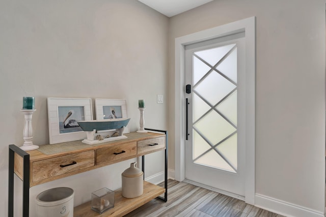 entryway with light wood-style floors and baseboards