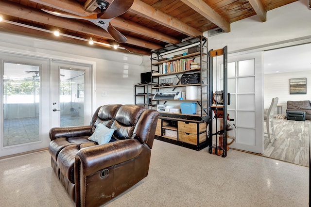 sitting room featuring french doors, beamed ceiling, wooden ceiling, and speckle patterned floor