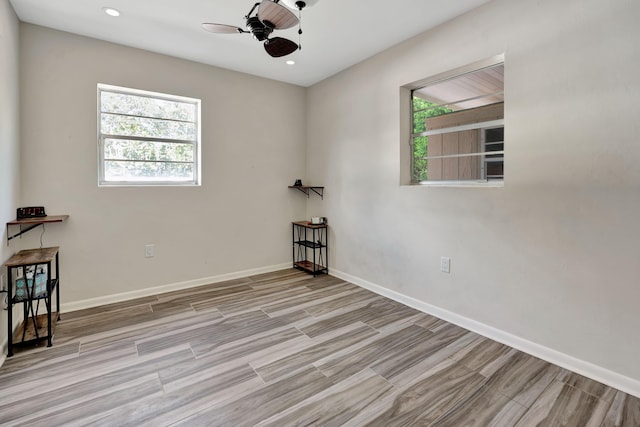 spare room featuring ceiling fan, wood finished floors, recessed lighting, and baseboards
