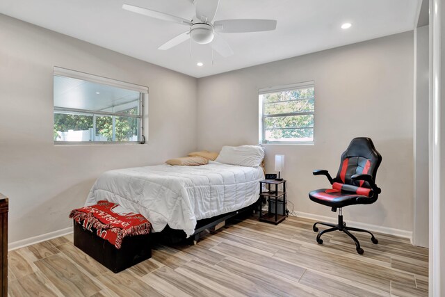bedroom featuring wood finished floors, baseboards, recessed lighting, and a ceiling fan
