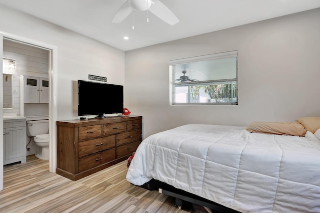 bedroom with ensuite bathroom, recessed lighting, light wood-type flooring, and ceiling fan