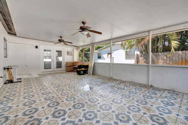unfurnished sunroom featuring french doors and ceiling fan