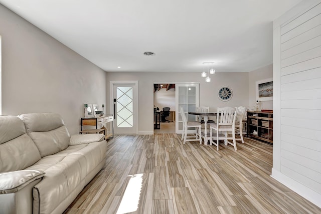 living area with light wood-style floors and baseboards