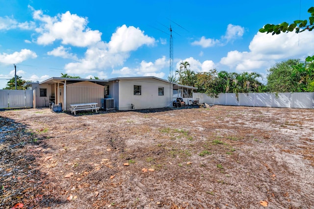 back of house featuring a fenced backyard and cooling unit