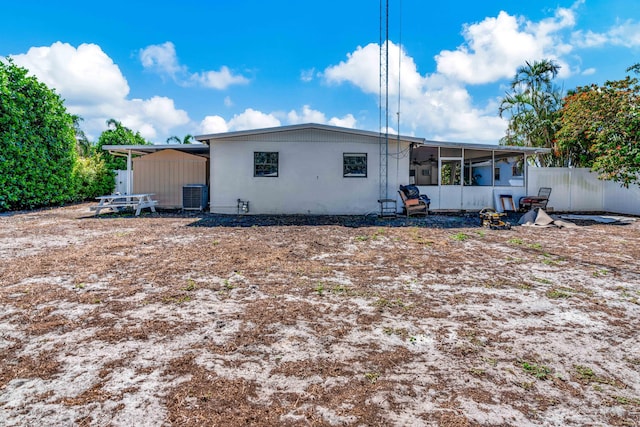 back of house featuring a sunroom, cooling unit, and fence