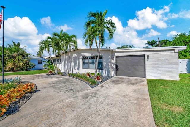 single story home featuring a garage and a front yard