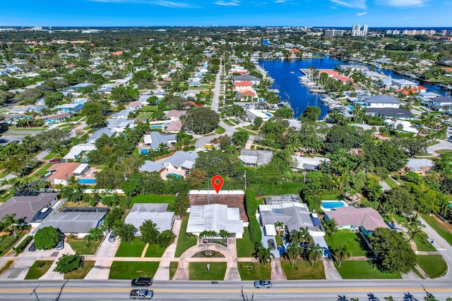 aerial view of property's location featuring a nearby body of water and nearby suburban area