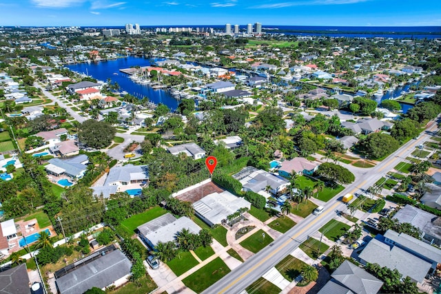 aerial overview of property's location with a nearby body of water and nearby suburban area
