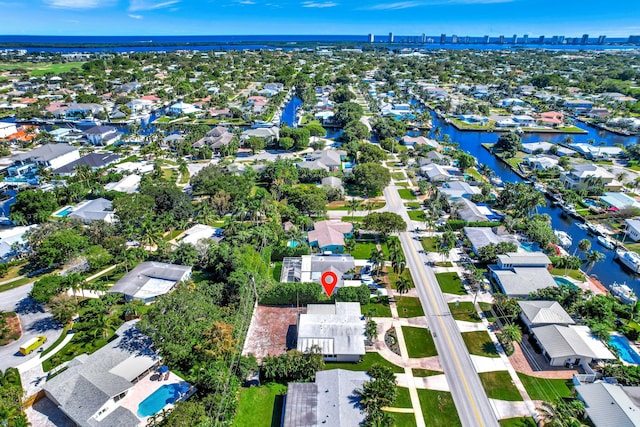 aerial view of property's location with a nearby body of water and nearby suburban area