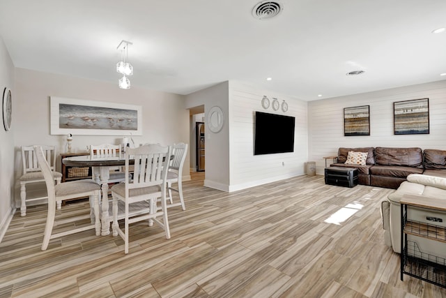 living room with baseboards, light wood finished floors, and recessed lighting
