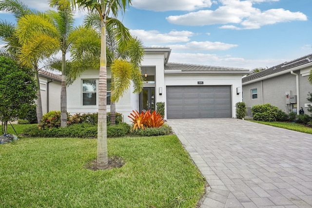 view of front of property with a garage and a front yard