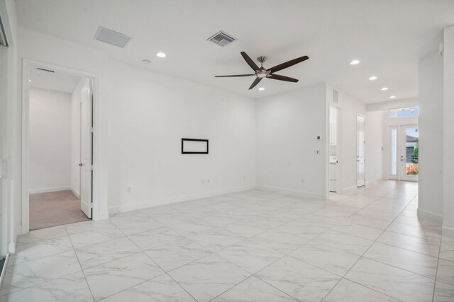 spare room with light carpet and ceiling fan