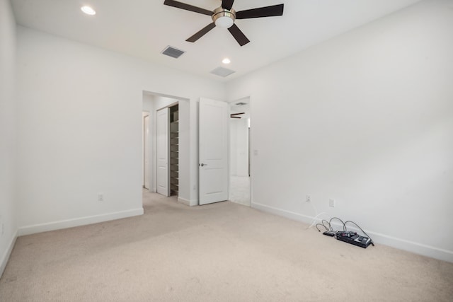 unfurnished bedroom with light colored carpet and ceiling fan