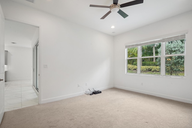 empty room with light colored carpet and ceiling fan