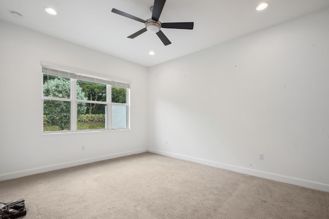 carpeted empty room featuring ceiling fan