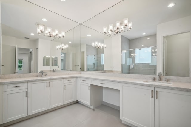 bathroom featuring vanity and a shower with door