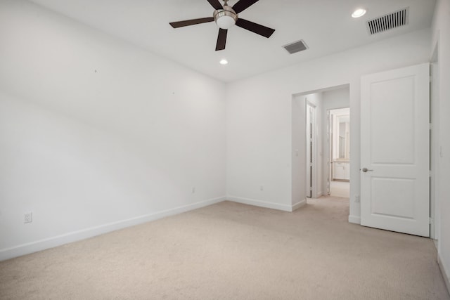 unfurnished room with light colored carpet and ceiling fan