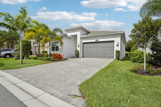 view of front of home with a front lawn and a garage