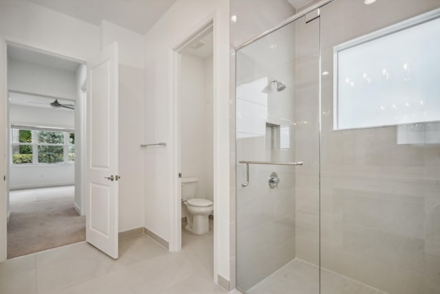 bathroom with toilet, walk in shower, tile patterned flooring, and ceiling fan