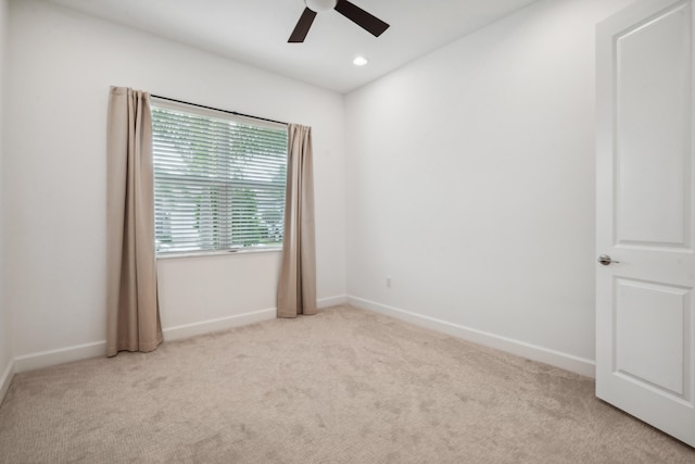 unfurnished room featuring ceiling fan and light carpet