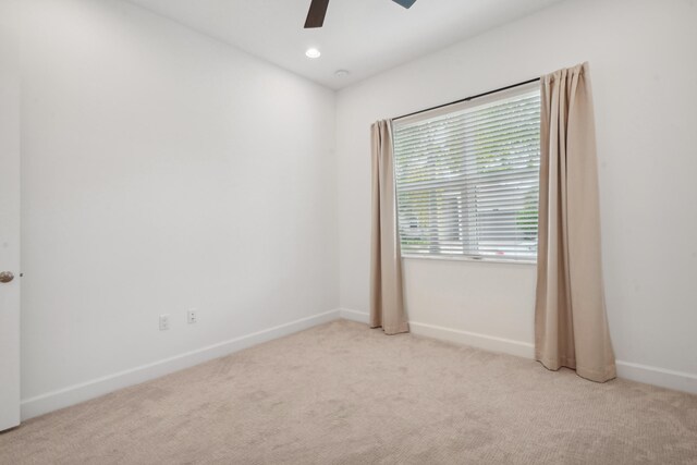 carpeted empty room featuring ceiling fan