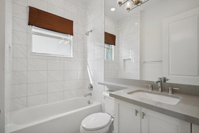 full bathroom with tiled shower / bath, toilet, and vanity