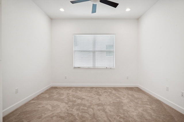 carpeted empty room featuring ceiling fan