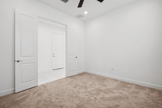 unfurnished bedroom featuring ceiling fan and light carpet